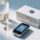 Professional studio shot of NFC-enabled smart packaging: beverage bottle and cosmetic box with visible NFC stickers, handheld NFC reader nearby, clean blue-gray background
