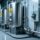 Professional industrial scene showing ATEX-certified RFID tags mounted on metal storage tanks and connected to an intrinsically safe RFID reader in a clean refinery environment