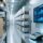 Professional industrial warehouse scene showing RFID tags on frozen food pallets, UHF desktop reader scanning, clean blue-gray color scheme, no text