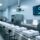 Professional industrial laundry facility with RFID-enabled linen sorting station, UHF reader scanning tagged textiles, clean modern setup