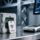Professional close-up of RFID ceramic tag embedded in cured concrete block, with UHF desktop reader scanning nearby, clean industrial lighting, blue-gray palette