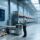 Professional warehouse scene showing RFID-enabled metal pallets, handheld scanner, and digital dashboard displaying RTI tracking data