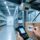 Professional warehouse setting showing RFID label application on product packaging, handheld scanner, and industrial RFID reader with clean blue-gray lighting
