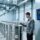 Professional industrial scene showing RFID-tagged chemical drums on metal pallets, handheld RFID scanner in use, clean warehouse background with digital dashboard display