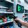 Professional warehouse interior with RFID tool crib system: metal shelving, handheld RFID scanner, tagged tools, digital dashboard, clean blue-gray lighting