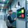 Professional warehouse scene showing RFID asset tracking: metal shelving with tagged equipment, handheld RFID scanner, and digital dashboard display