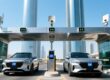Smart parking system in Dubai with UHF windshield tags on vehicles and RFID readers at entrance gates, modern city skyline in background