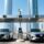 Smart parking system in Dubai with UHF windshield tags on vehicles and RFID readers at entrance gates, modern city skyline in background