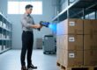 Engineer testing UHF RFID tag read range with handheld scanner in warehouse