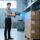 Engineer testing UHF RFID tag read range with handheld scanner in warehouse